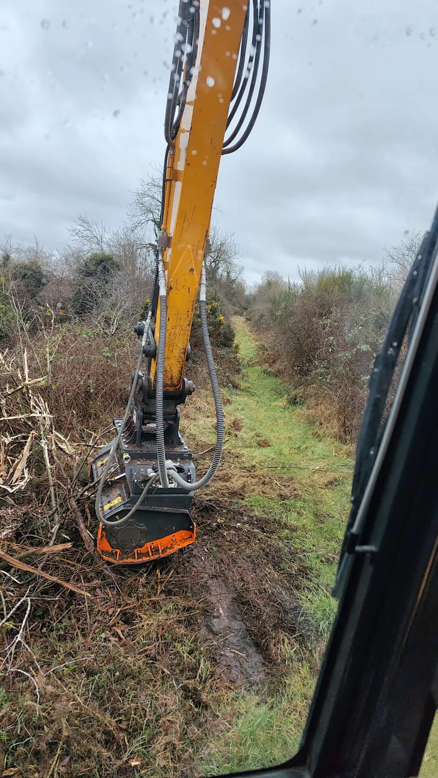 Tracked forestry mulching attachment clearing dense vegetation