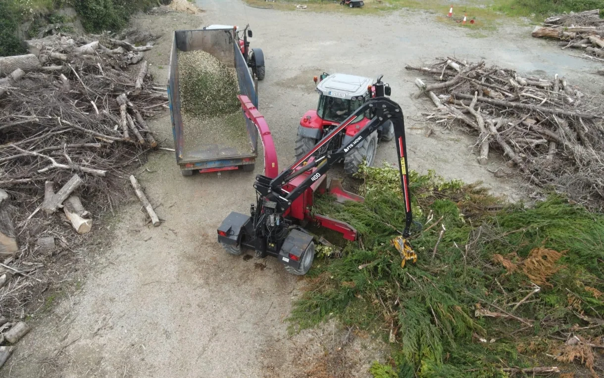 Tree waste being handled during a site clearance project